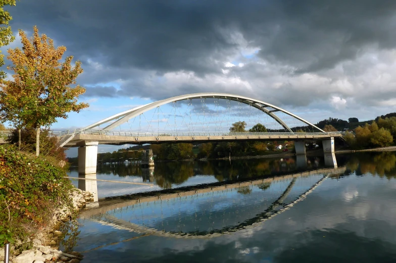 a bridge over water on a cloudy day