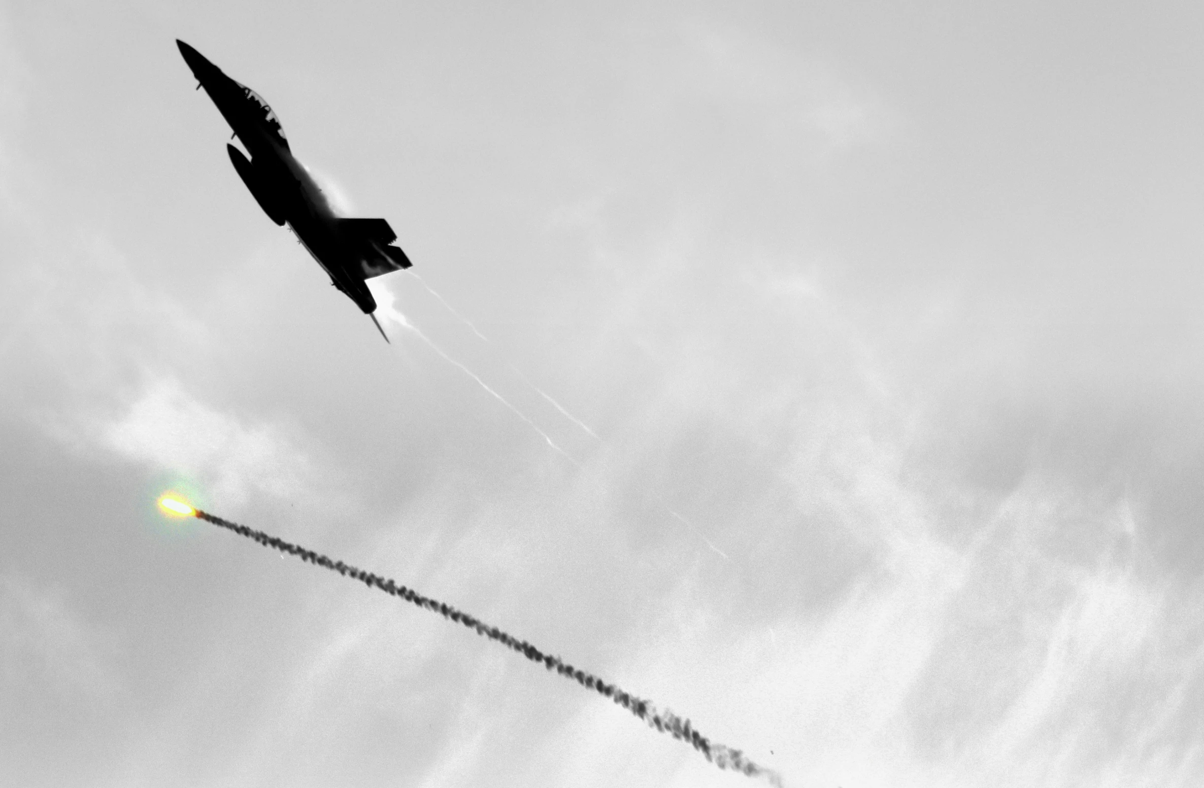 an air plane has a contrail in the sky