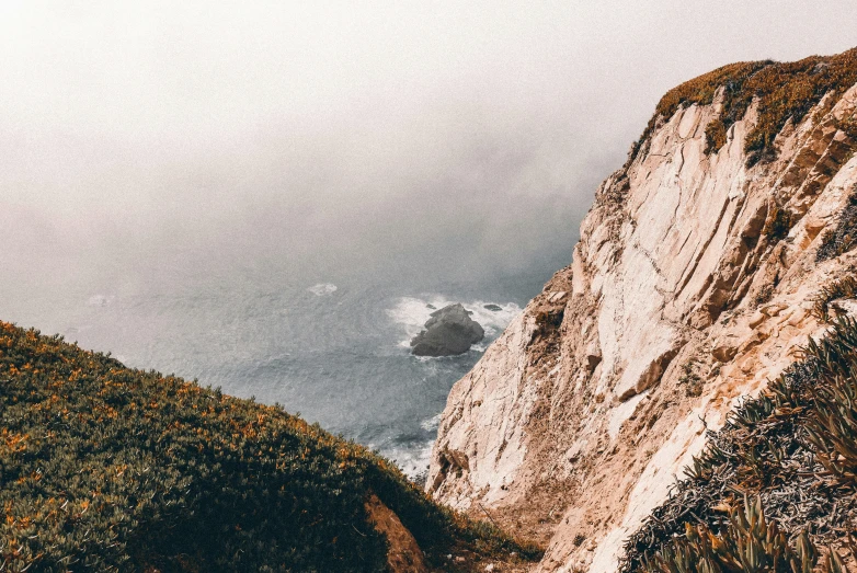 a tall white cliff sitting on the side of a mountain