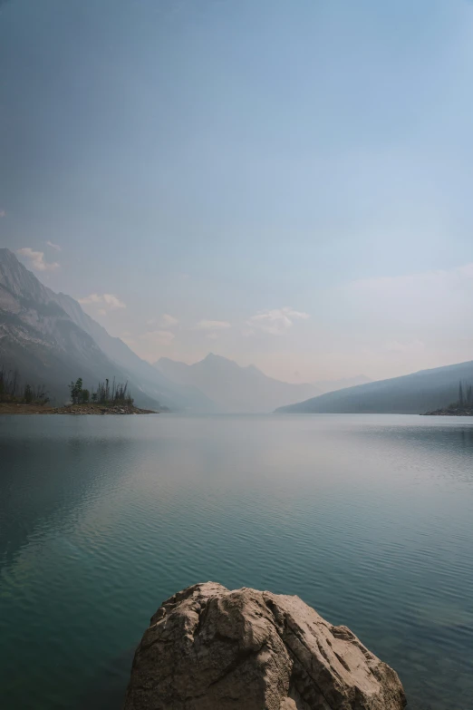 an empty bay with clear water on the mountains