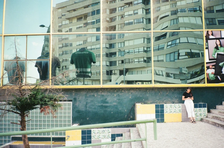 a large building reflecting people's life in its windows