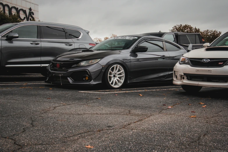 two black and white cars parked in a parking lot