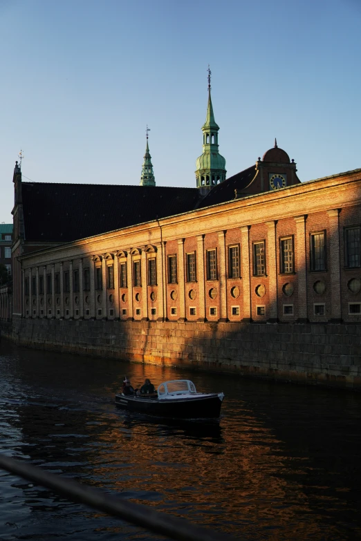 a boat in the water near an old building