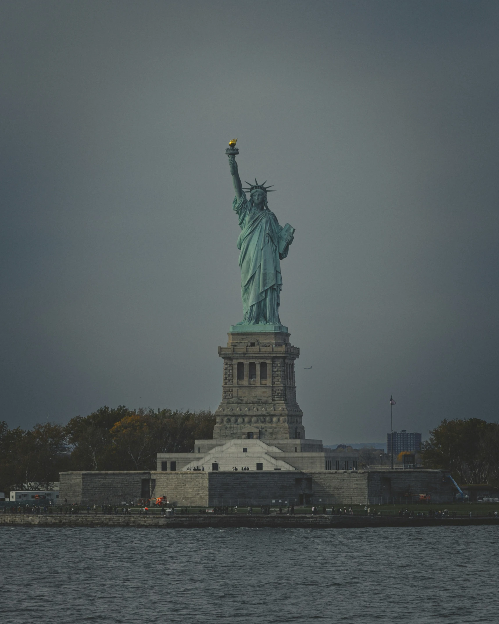 the statue of liberty is on a cloudy day