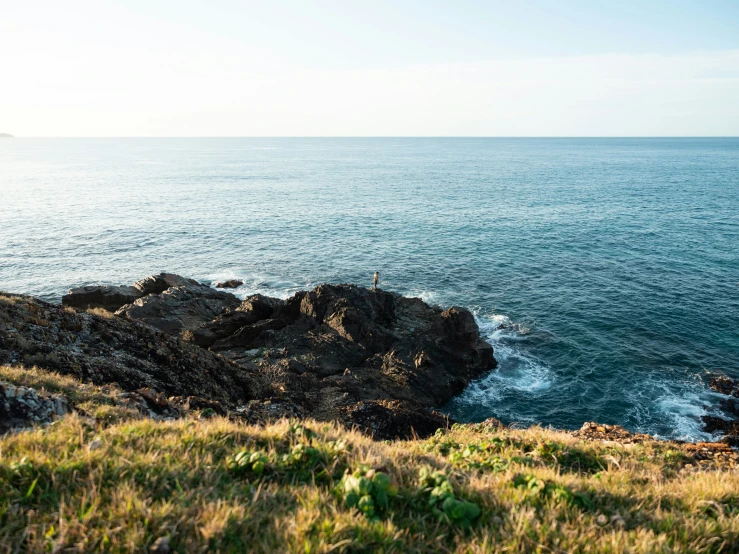 a couple of rocks that are near the ocean