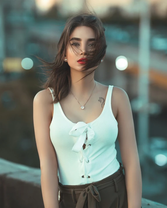 an asian woman is wearing a white top