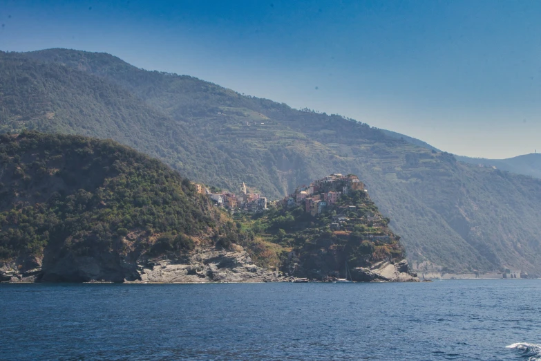 a view of an ocean with houses on a hill