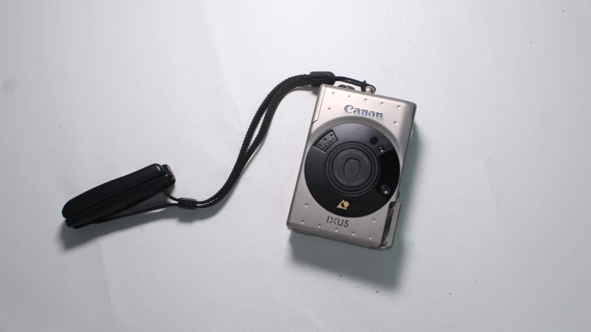 an old digital camera with a strap attached