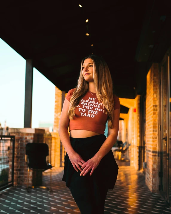 a beautiful young woman wearing a top with the words dance like you do