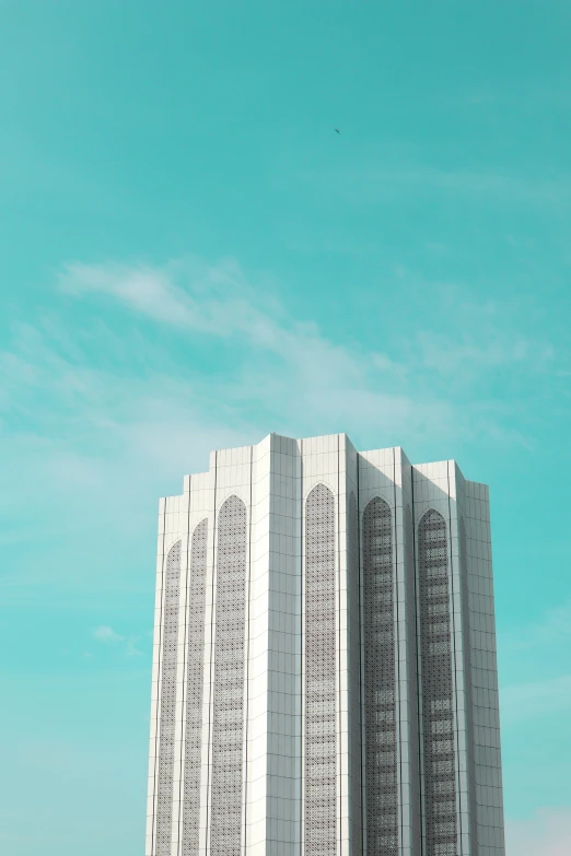 a tall white building with several writing written on the side