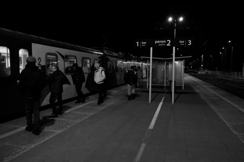 a group of people waiting at the entrance to the train