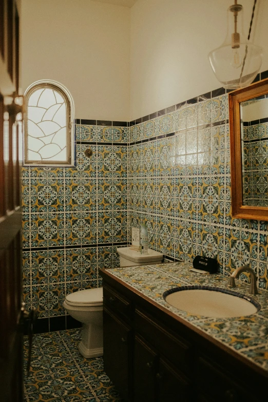 a bathroom with tiled walls, floor and sink