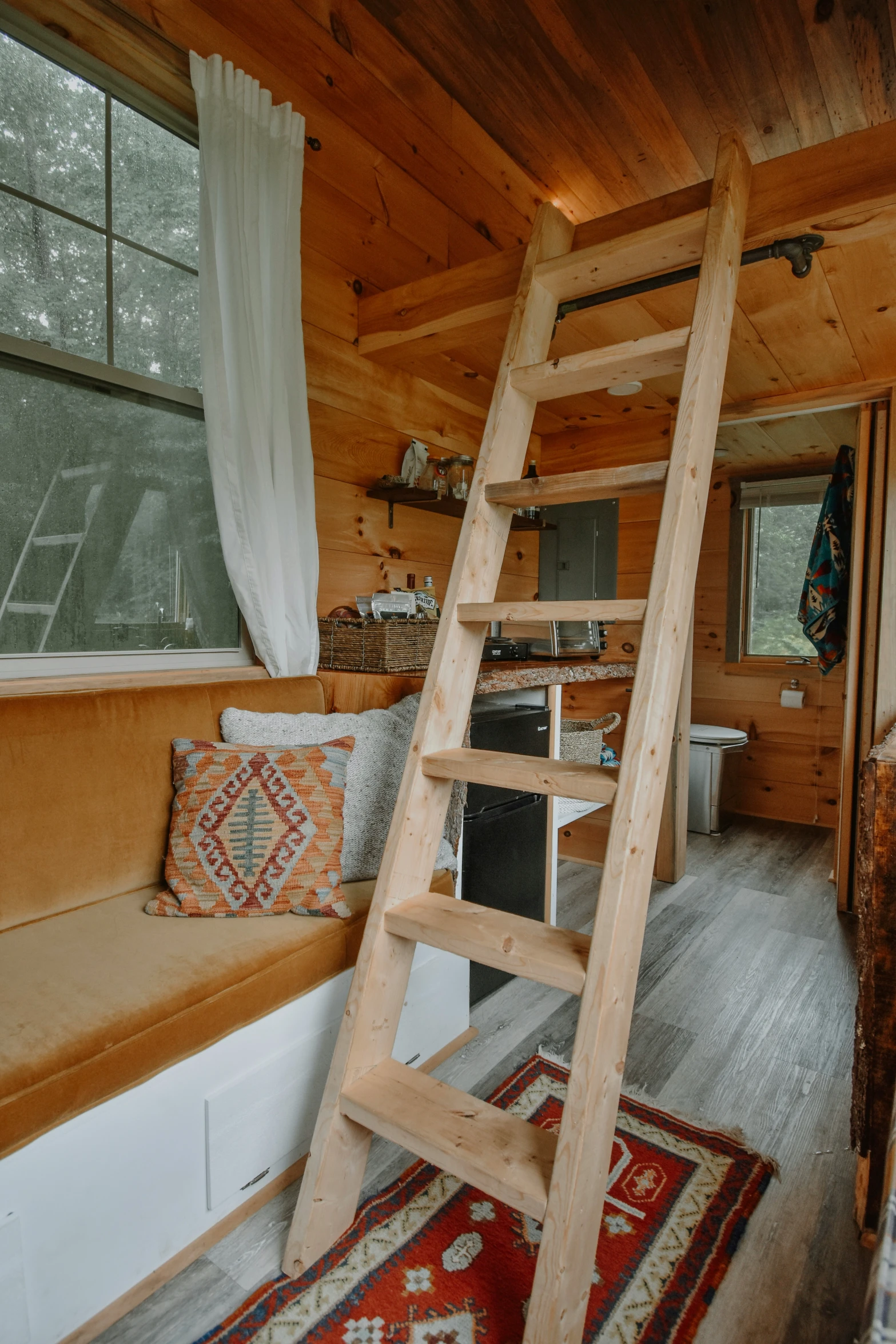 a ladder is built into the wall in the cabin