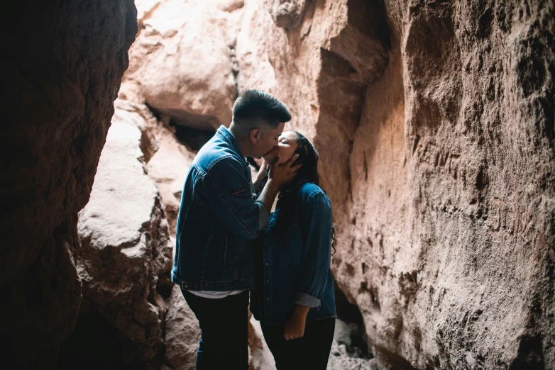 a couple of people standing in some rocks