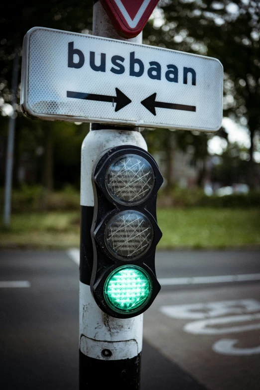 this street sign shows that buses can turn green