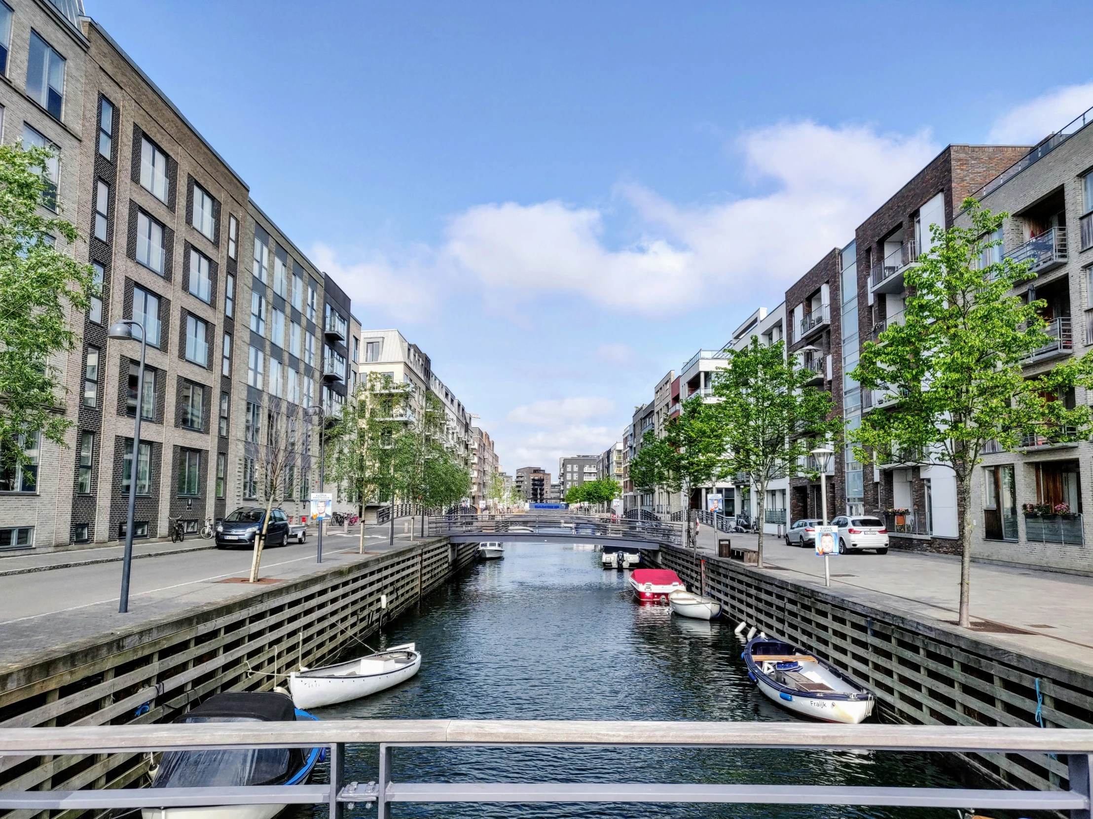 boats floating down a river lined with brick buildings