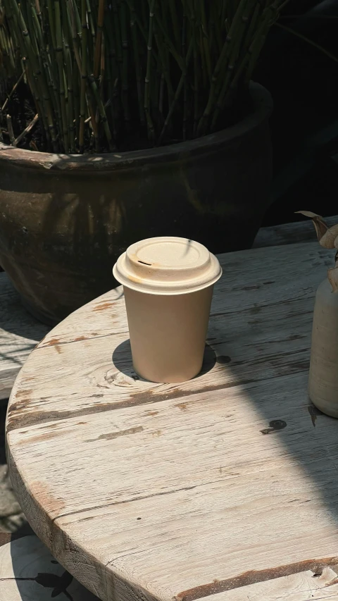 a ceramic pot is sitting on a stone table