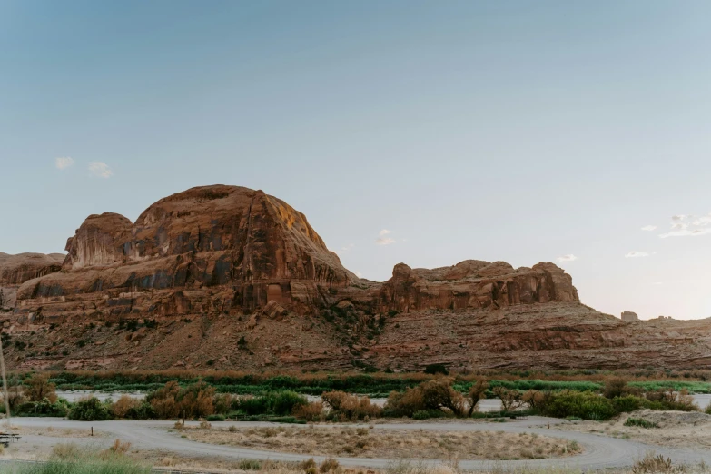 a hill with large rock formations in a desert