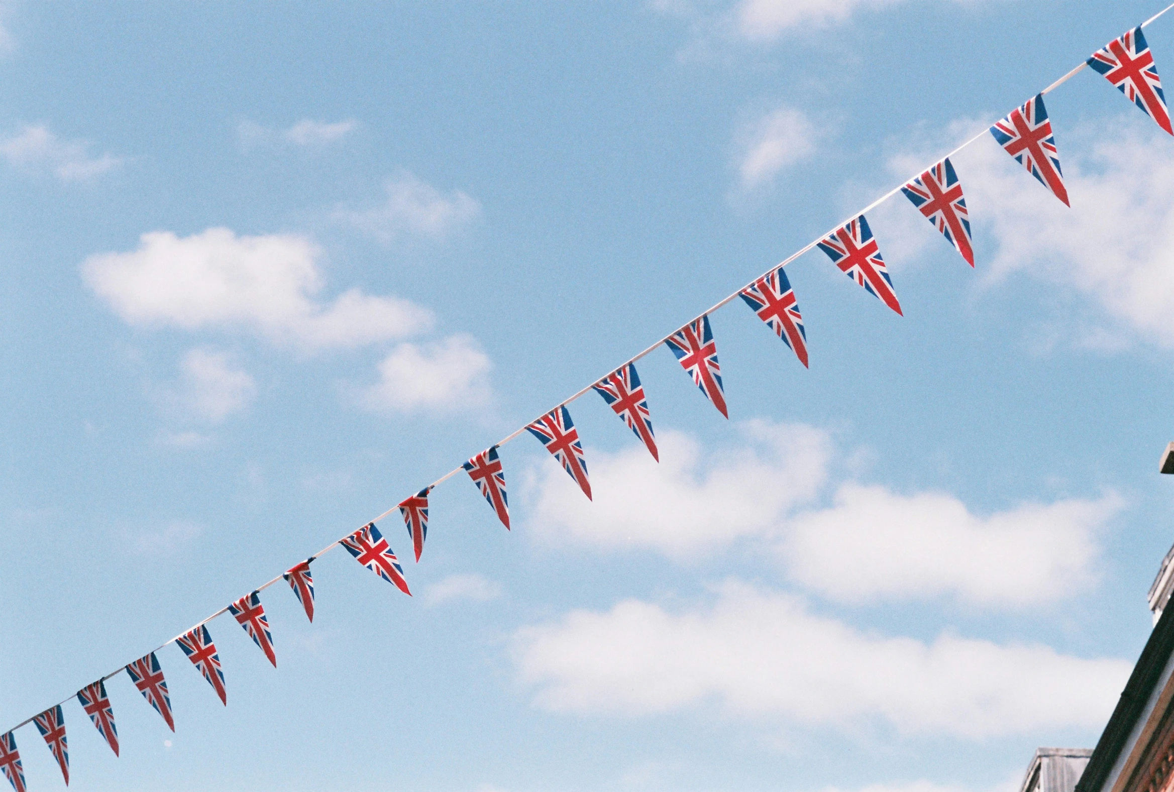 several british flags are strung from a line