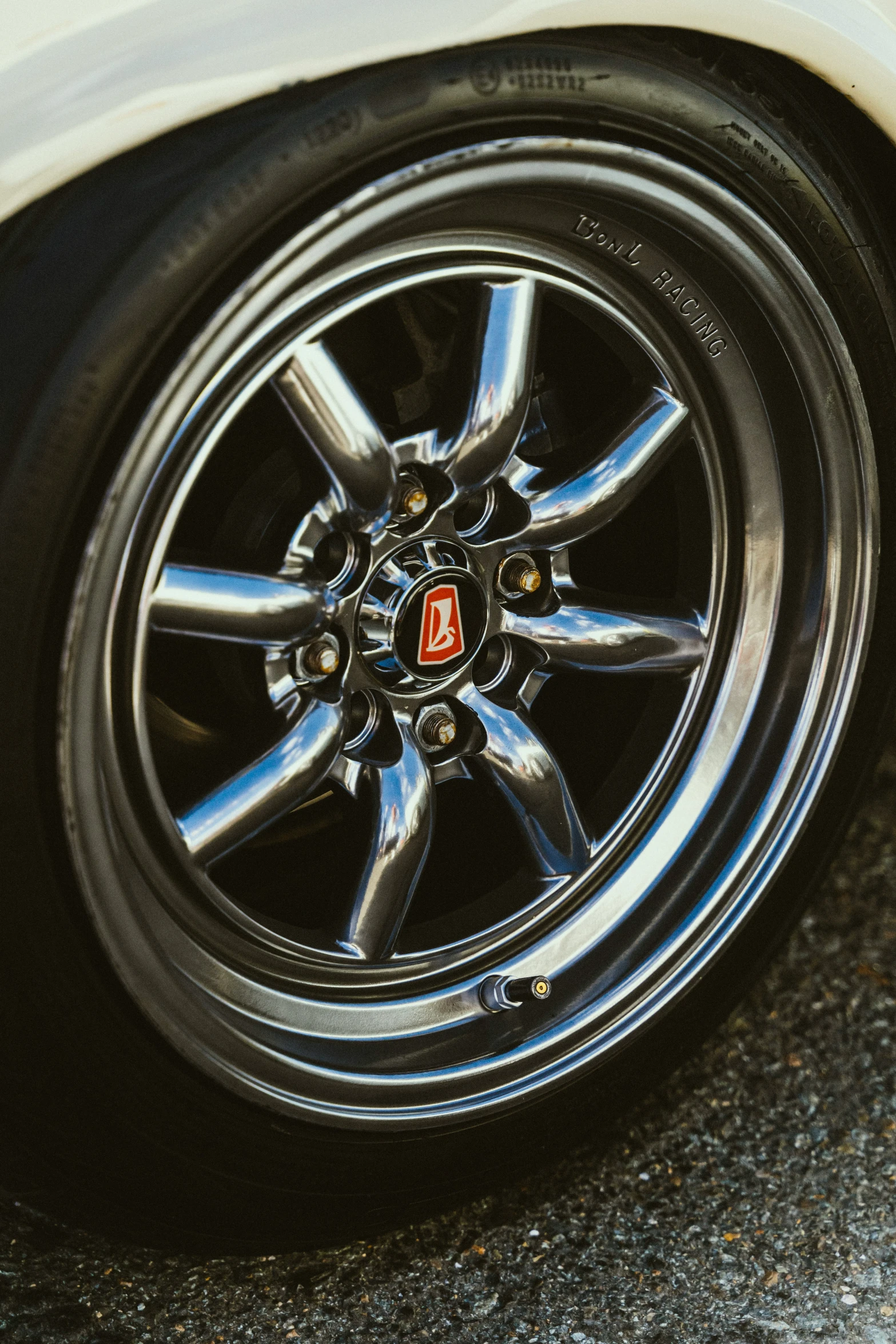 the wheel of a car that is on a road