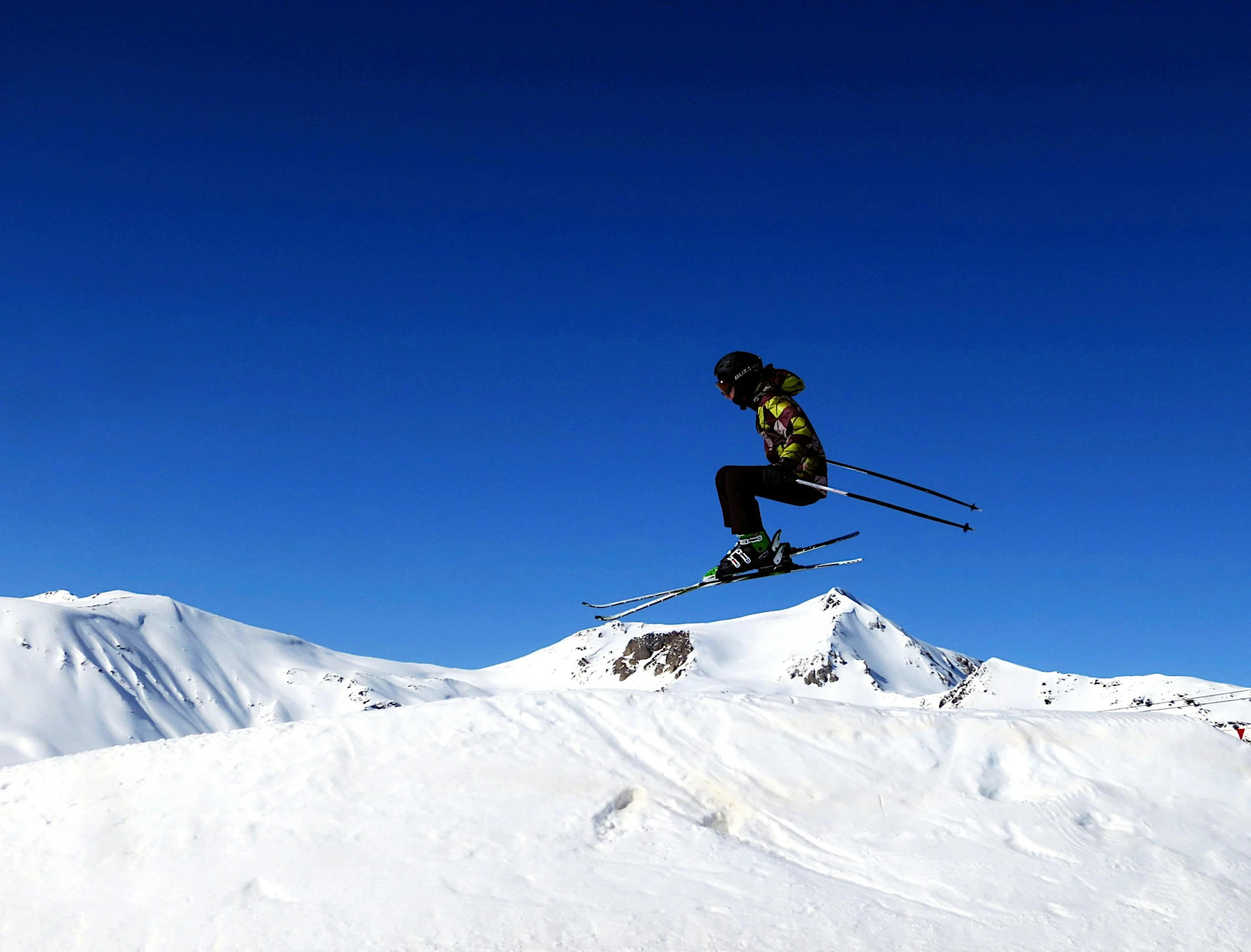the skier is headed into the air on his skis