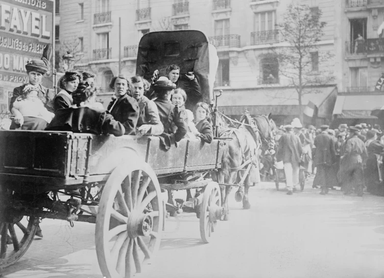 people ride in an open carriage with horse and buggy on the street