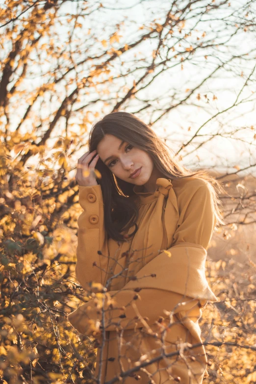 a woman is walking through a leaf filled field