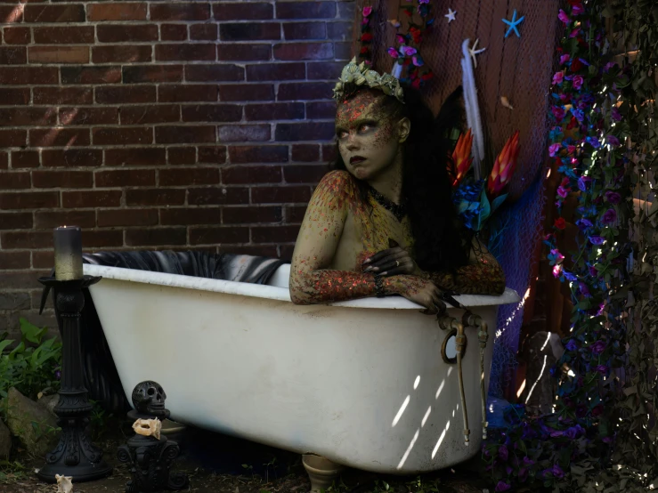 a woman with makeup is leaning out the side of a tub