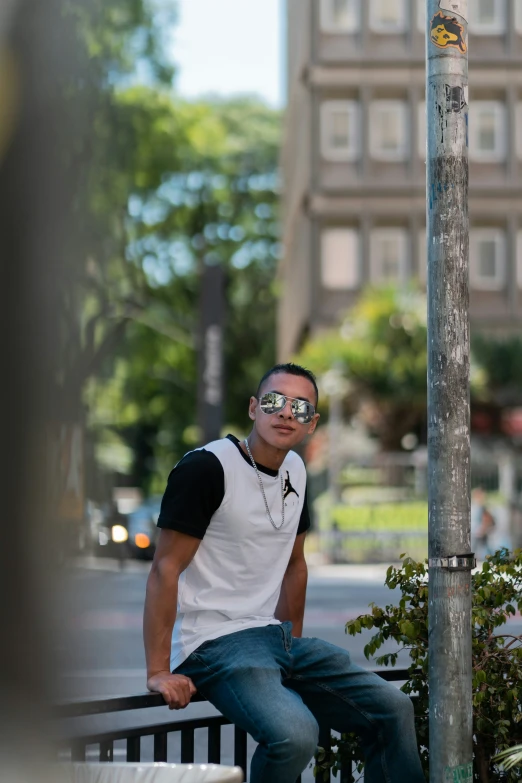 man sitting on a park bench posing for the camera