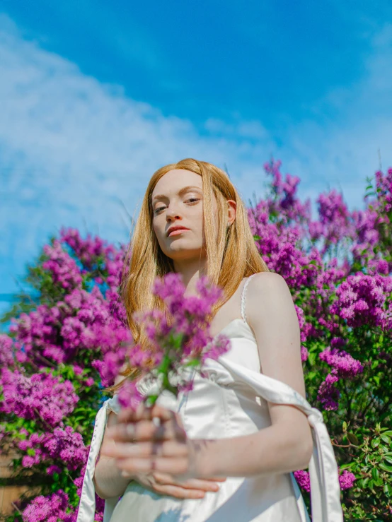 a woman is holding the hand of a small flower