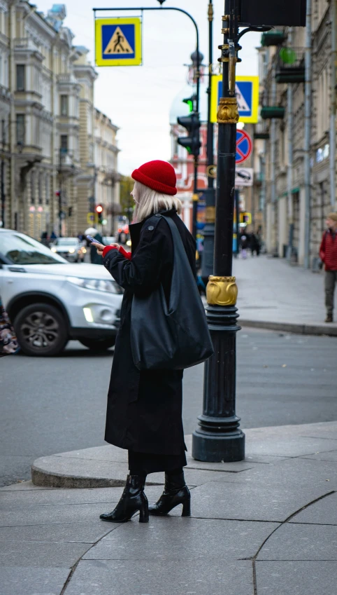 a lady in red and black checking her cell phone