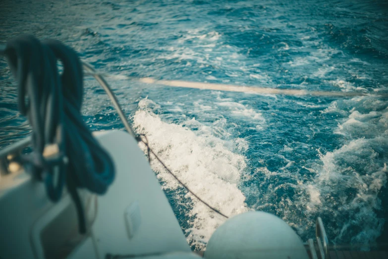 a rope attached to a boat next to the ocean