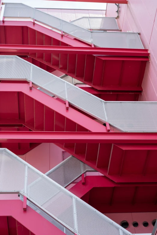 looking up at a multicolored staircase next to a building