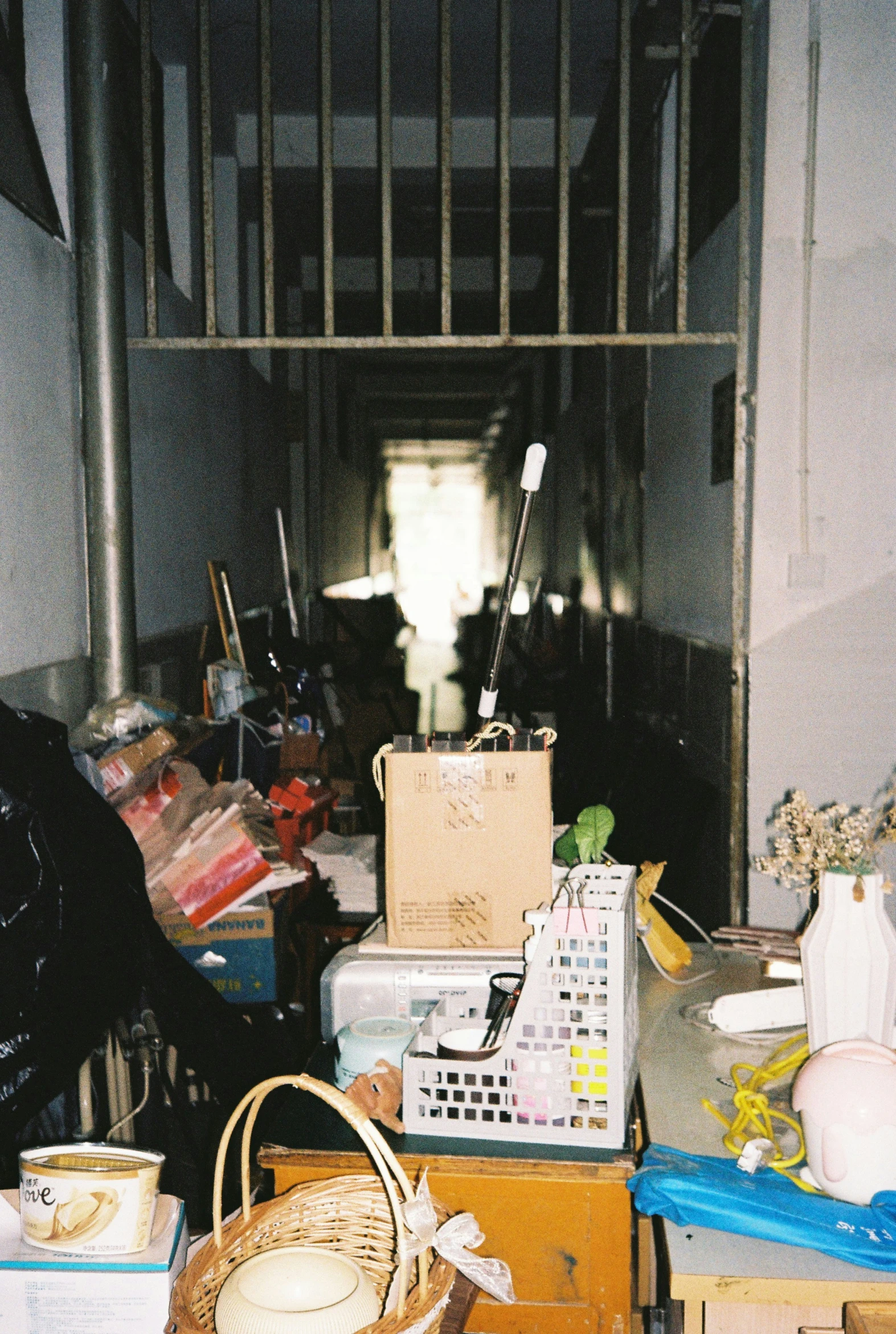 many different things in a room with bars and baskets on the tables