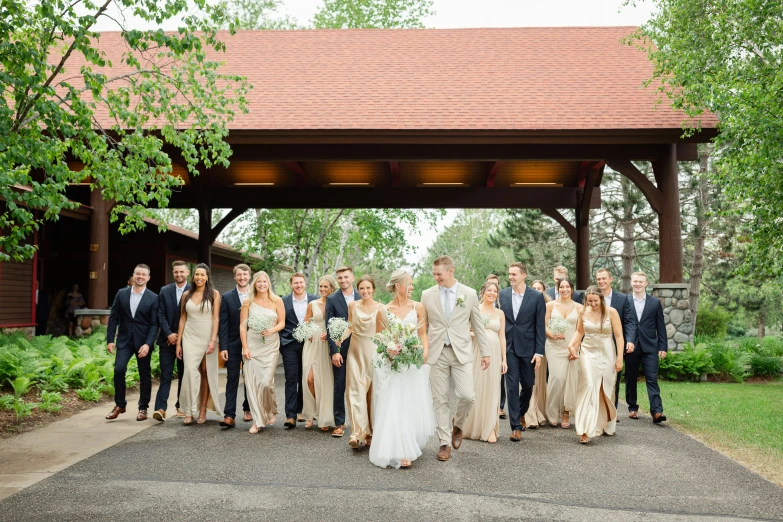 an elegant wedding party stands underneath the gazebo