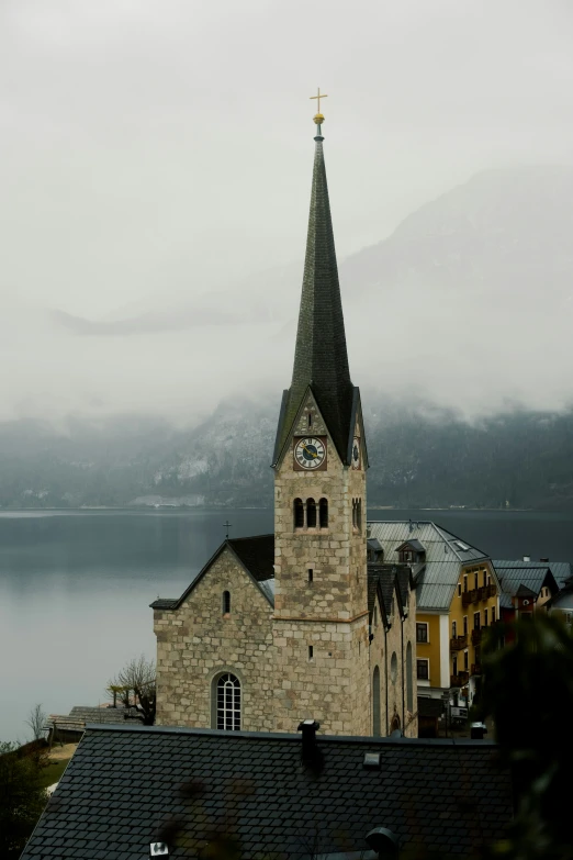 the clock tower is overlooking the mountains of lake geneva