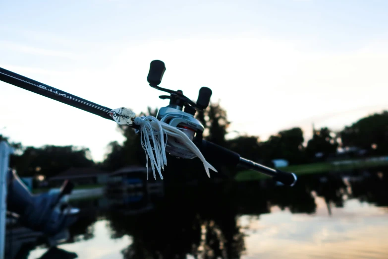 an overhead view of a fishing rod, caught in the air from the water