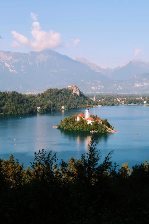 an island with an house on a lake