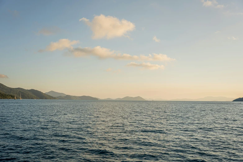 some water mountains and clouds and some blue sky