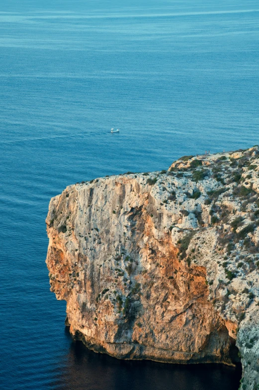 a boat floating in the ocean off the coast