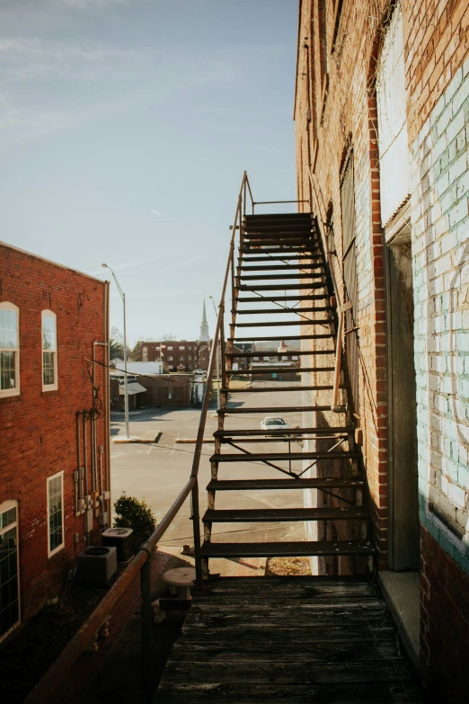 the stairs lead up to a brick building