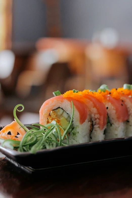 a sushi on a small plate on top of a table