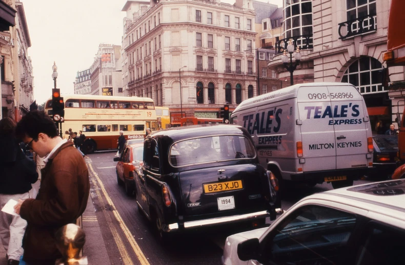 a city street filled with traffic and pedestrians