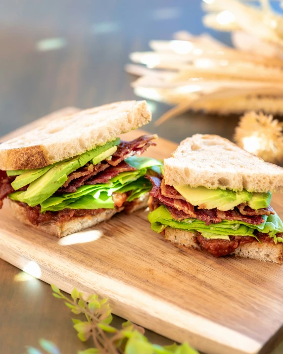 an up close s of a sandwich that is sitting on a  board