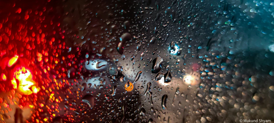 rain drops are seen on the windshield of a car