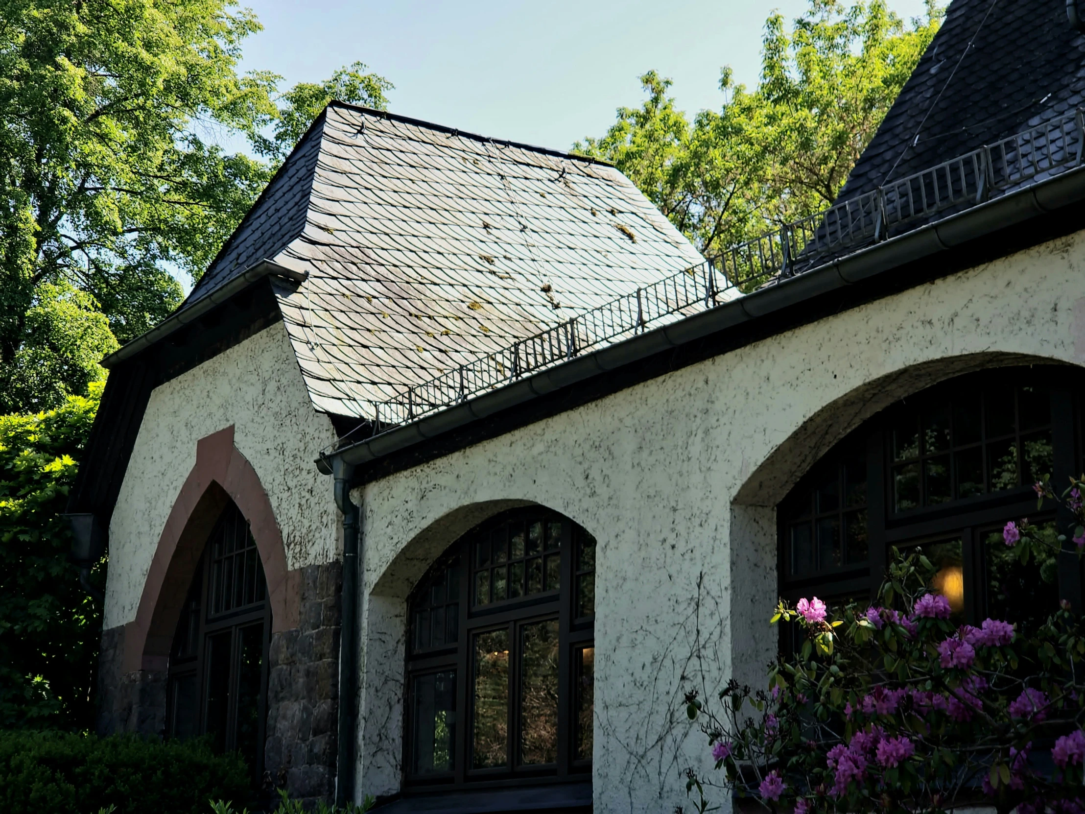 a white cottage with a small tower and lots of windows