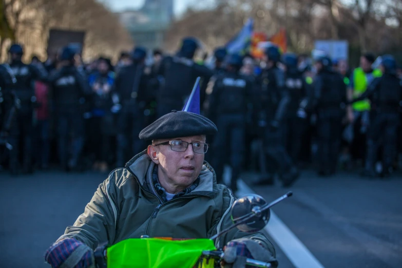 a man wearing a party hat while riding a motorcycle