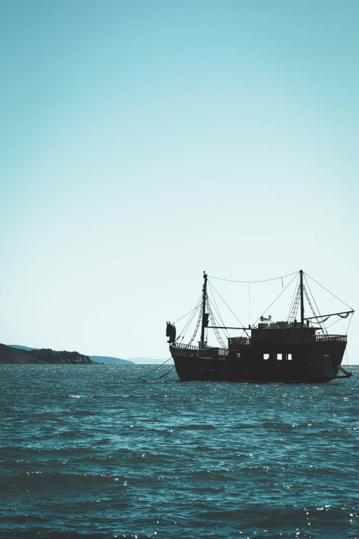 a ship traveling down the ocean on calm water