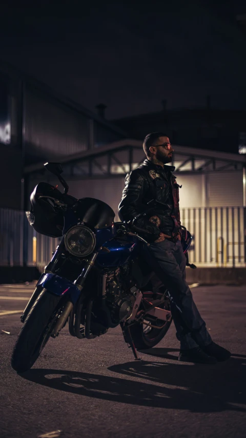 a man sitting on a motorcycle parked in a parking lot