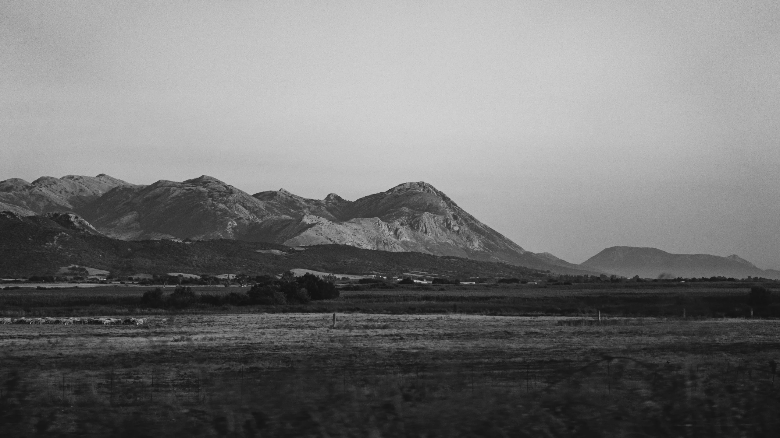 some mountains are in the distance and very cloudy